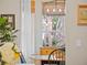 Charming dining area bathed in natural light, with stylish light fixtures and a view to the exterior at 6037 Lake Erie Rd, Groveland, FL 34736