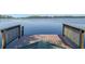 Scenic view from a wooden dock of a calm, serene lake with lush trees at 6037 Lake Erie Rd, Groveland, FL 34736