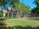 Charming home with rocking chair front porch and mature landscaping, nestled among mature trees at 6037 Lake Erie Rd, Groveland, FL 34736