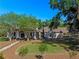 Charming home with a well-manicured lawn and a covered carport, surrounded by mature trees at 6037 Lake Erie Rd, Groveland, FL 34736