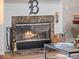 Close-up of a fireplace with a marble surround, glass doors, and decorative accents at 6037 Lake Erie Rd, Groveland, FL 34736