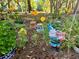 Colorful garden scene with a whimsical garden gnome and vibrant cosmos flowers creating a cheerful atmosphere at 6037 Lake Erie Rd, Groveland, FL 34736