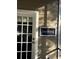 Charming front door with decorative Fireflies sign hanging on the wall at 6037 Lake Erie Rd, Groveland, FL 34736