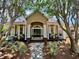 Charming home exterior featuring a welcoming porch with rocking chairs and beautiful landscaping at 6037 Lake Erie Rd, Groveland, FL 34736