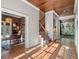 Hallway with gleaming hardwood floors leading to various rooms and staircase at 6037 Lake Erie Rd, Groveland, FL 34736