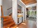 Hallway leading to living room with wood-flooring, a staircase, and a custom dry bar with mini-fridge at 6037 Lake Erie Rd, Groveland, FL 34736