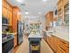 Bright, open kitchen featuring stainless appliances, central island, and adjacent dining area at 6037 Lake Erie Rd, Groveland, FL 34736