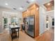 Well-equipped kitchen with custom wood cabinetry, stainless steel appliances, and a portable island, perfect for cooking at 6037 Lake Erie Rd, Groveland, FL 34736