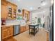 Modern kitchen with stainless steel appliances, farmhouse sink, island, and wooden cabinets at 6037 Lake Erie Rd, Groveland, FL 34736