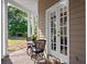 Charming side porch with outdoor seating, perfect for enjoying the peaceful surroundings at 6037 Lake Erie Rd, Groveland, FL 34736