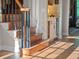 Elegant staircase with wooden treads and dark wood railings, complemented by a beverage center at 6037 Lake Erie Rd, Groveland, FL 34736