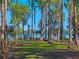 Scenic waterfront view with lush trees, a charming gazebo, a wooden dock, and serene water at 6037 Lake Erie Rd, Groveland, FL 34736