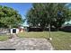 Backyard view featuring a patio, shed, and mature trees at 607 Brittany Ct, Casselberry, FL 32707