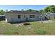 Back exterior of home with patio and large backyard area at 607 Brittany Ct, Casselberry, FL 32707