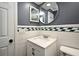 Bathroom with a tiled vanity and storage cabinet at 607 Brittany Ct, Casselberry, FL 32707