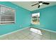 Bright bedroom with turquoise walls, neutral tile, and windows for natural light at 607 Brittany Ct, Casselberry, FL 32707