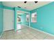 Bedroom featuring turquoise walls, mirror closet and tile flooring at 607 Brittany Ct, Casselberry, FL 32707