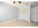 Neutral bedroom featuring a ceiling fan, tile flooring, and closet for ample storage at 607 Brittany Ct, Casselberry, FL 32707