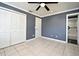 Bedroom with a closet, tile flooring and a ceiling fan at 607 Brittany Ct, Casselberry, FL 32707