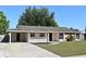 Cozy single-story home featuring a neat lawn, covered porch, and driveway at 607 Brittany Ct, Casselberry, FL 32707
