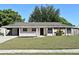 Charming one-story home with a well-maintained lawn and inviting front porch at 607 Brittany Ct, Casselberry, FL 32707