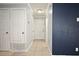Hallway with tile flooring, neutral paint, and multiple doors for bedrooms and closets at 607 Brittany Ct, Casselberry, FL 32707