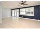 Bright living room showcasing tile floors, ceiling fan, and french doors to the backyard at 607 Brittany Ct, Casselberry, FL 32707