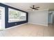 A cozy living room featuring tile flooring, a ceiling fan, and a large window for ample natural light at 607 Brittany Ct, Casselberry, FL 32707