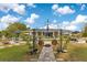 Expansive backyard featuring a wrought iron arbor, patio seating, and beautifully landscaped grounds at 6816 Greengrove Blvd, Clermont, FL 34714