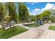 Secluded backyard featuring an artificial turf lawn, a fish pond, and varied lounge seating at 6816 Greengrove Blvd, Clermont, FL 34714