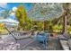 Landscaped backyard featuring a hammock, seating, and shade umbrellas, perfect for outdoor relaxation and entertaining at 6816 Greengrove Blvd, Clermont, FL 34714