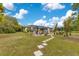 Sprawling backyard with lush lawn, spacious patio, mature trees, and serene outdoor living spaces at 6816 Greengrove Blvd, Clermont, FL 34714