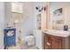 Well-lit bathroom features a unique vanity, linen closet, framed mirror, and decorative window at 6816 Greengrove Blvd, Clermont, FL 34714