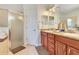 Bright bathroom with double sinks, spacious shower stall, and a neutral color palette, offering a clean and modern look at 6816 Greengrove Blvd, Clermont, FL 34714