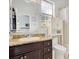 Bathroom featuring a vanity with dark cabinets, granite countertops, and a framed mirror at 6816 Greengrove Blvd, Clermont, FL 34714