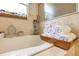 A close up of a corner bathtub space with decor and stacked white towels on a tray at 6816 Greengrove Blvd, Clermont, FL 34714