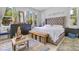 Light-filled bedroom with a tufted headboard, soft natural light, and light, neutral tones in the design at 6816 Greengrove Blvd, Clermont, FL 34714