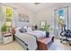 Bright bedroom with two windows with soft natural light and plants, and the word 'DREAM' displayed on the bed at 6816 Greengrove Blvd, Clermont, FL 34714