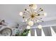 Unique sputnik chandelier with adjacent shelves and plants at 6816 Greengrove Blvd, Clermont, FL 34714