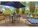 Close-up of the inviting outdoor deck furnished with a dining set and lounge chairs, set amidst a tranquil garden at 6816 Greengrove Blvd, Clermont, FL 34714