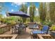 Inviting outdoor deck furnished with a dining set and lounge chairs, set amidst a tranquil garden oasis at 6816 Greengrove Blvd, Clermont, FL 34714