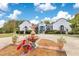 Elegant home exterior with a fountain centerpiece, showcasing beautiful landscaping and a welcoming entrance at 6816 Greengrove Blvd, Clermont, FL 34714