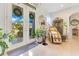 Inviting foyer featuring double doors, tile flooring, and stylish decor, creating a warm and welcoming entrance at 6816 Greengrove Blvd, Clermont, FL 34714