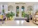 Bright and airy foyer with double doors, tile flooring, and tasteful decor, creating a welcoming ambiance at 6816 Greengrove Blvd, Clermont, FL 34714