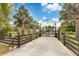 Grand gated entrance with intricate ironwork and mature landscaping, providing privacy and curb appeal at 6816 Greengrove Blvd, Clermont, FL 34714
