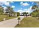 Expansive front yard featuring a long driveway, lush lawn, and stately landscaping leading to a beautiful home at 6816 Greengrove Blvd, Clermont, FL 34714