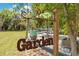 Enchanting garden entrance with decorative signage leading to a serene outdoor seating area at 6816 Greengrove Blvd, Clermont, FL 34714