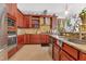 Traditional kitchen featuring wooden cabinetry, granite countertops, and stainless steel appliances at 6816 Greengrove Blvd, Clermont, FL 34714