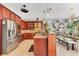 Kitchen with a granite countertop island and stainless steel appliances at 6816 Greengrove Blvd, Clermont, FL 34714