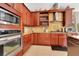 Close-up of kitchen with stainless steel appliances and wooden cabinets at 6816 Greengrove Blvd, Clermont, FL 34714